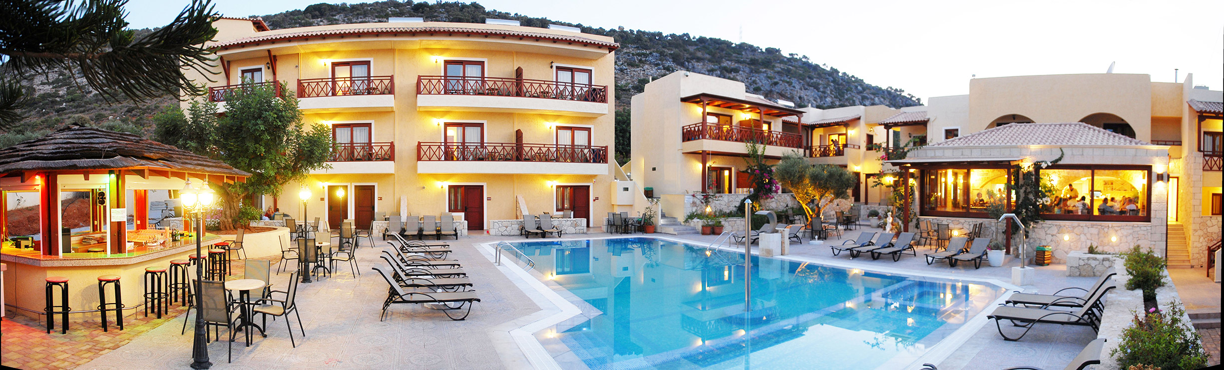 Cactus village hotel pool that also contains a bar